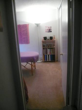 o - Bedroom with massage table from hallway